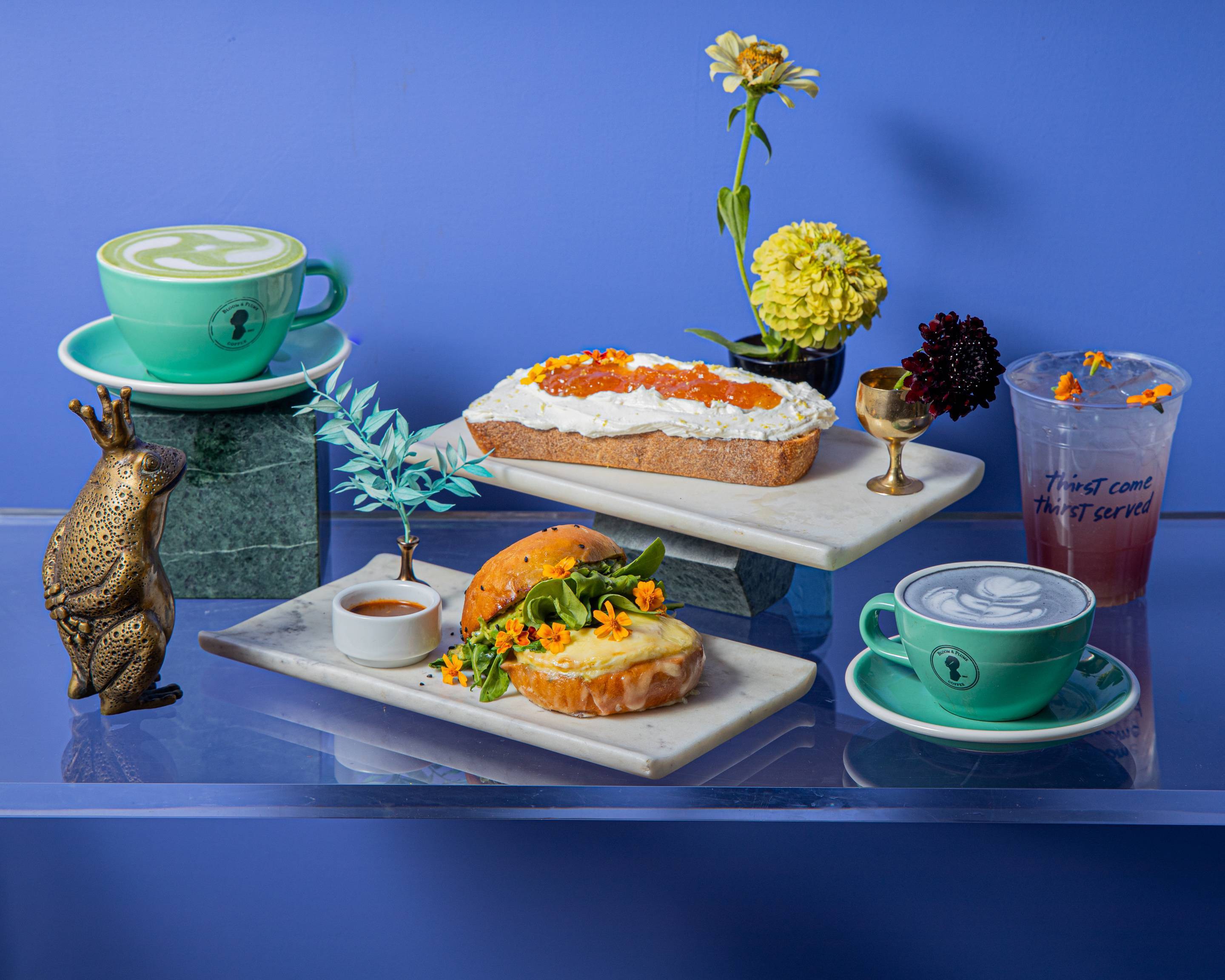 Coffee drinks and plates styled on a bright background